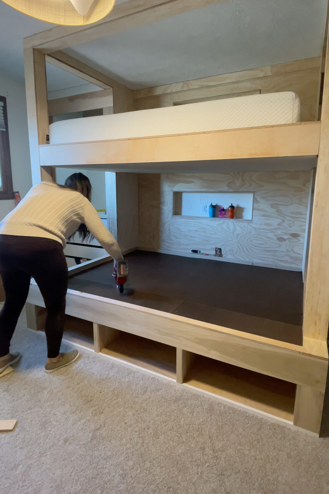 Building DIY bunk beds in a kid's room makeover.